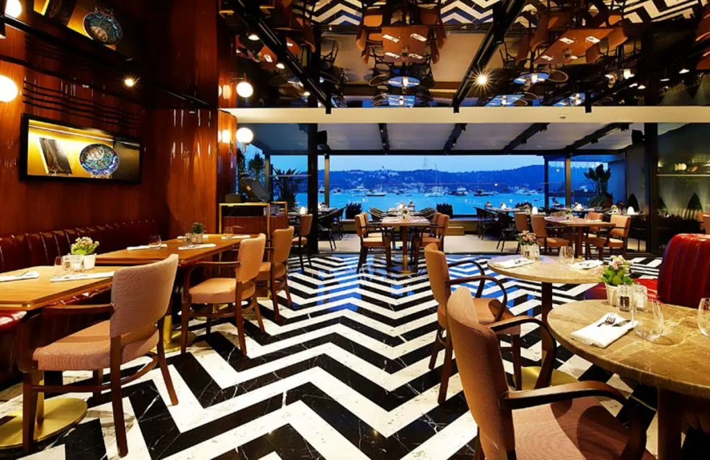 Dining room of Divan Brasserie in Bebek with a chevron marble floor and Bosphorus view