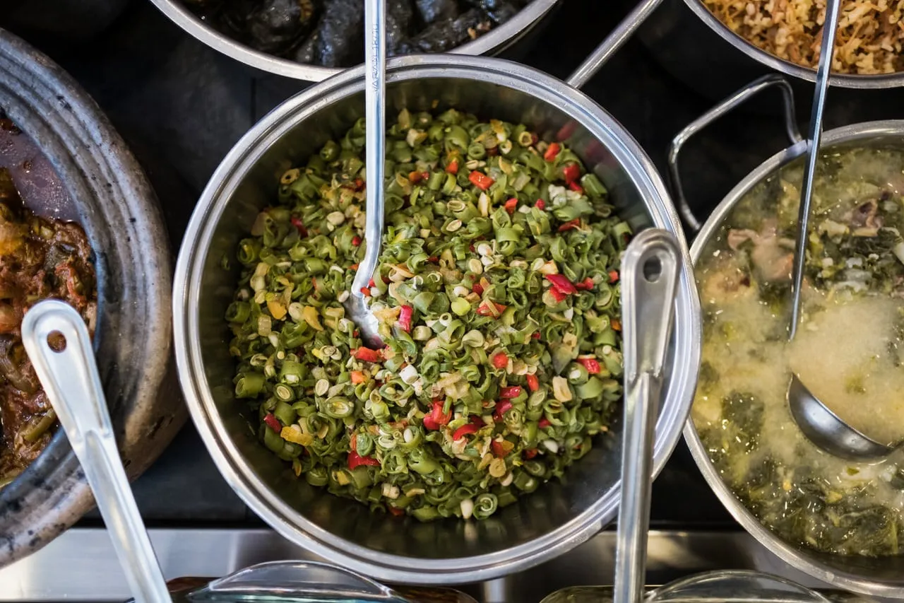 Large pot of cooked leeks dish among other Turkish dishes at Çiya restaurant, istanbul food walk