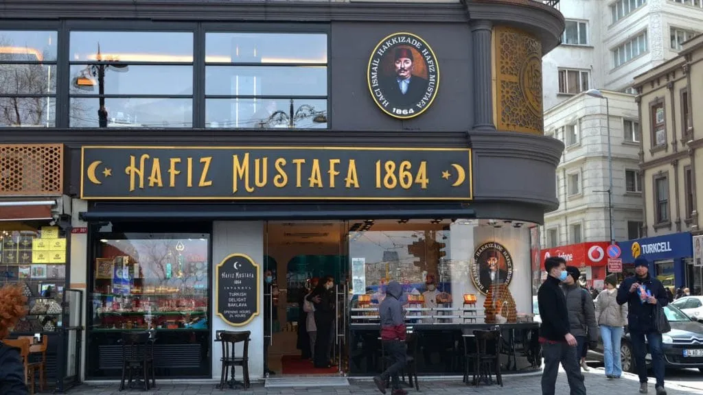 Hafız Mustafa 1864 storefront with gold lettering and the founder's portrait medallion above the door