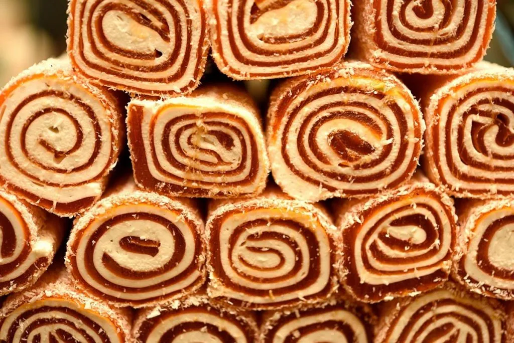 Stacked rolls of spiral Turkish delight dusted with coconut