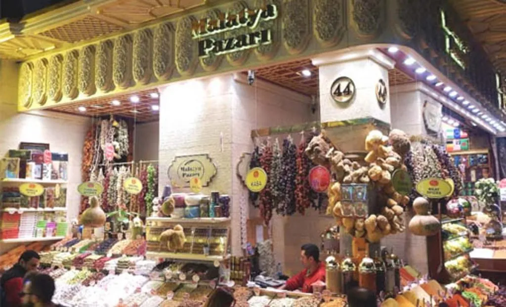 Malatya Pazarı stall in the Spice Market with hanging cevizli sucuk and counters of dried fruit and nuts