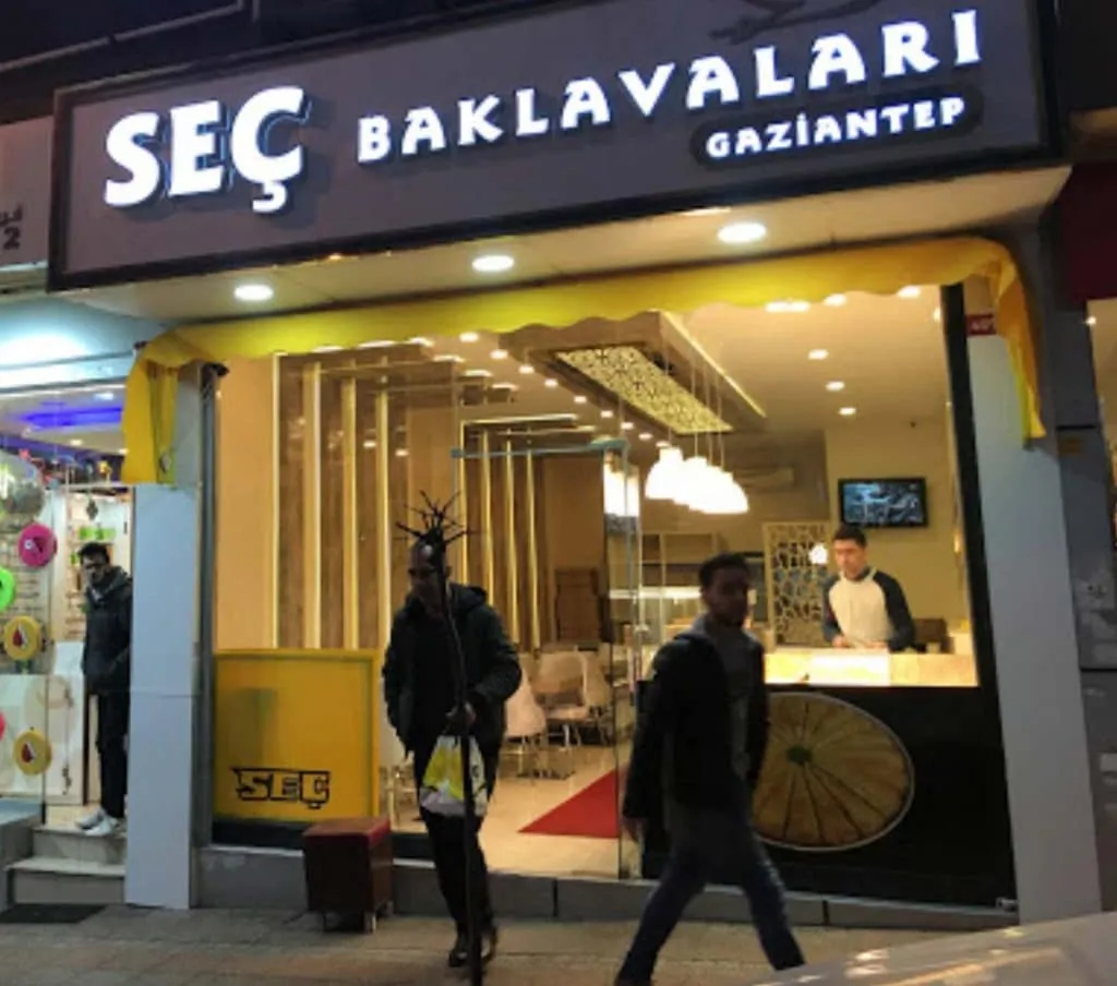 Seç Baklavaları storefront lit up at night with the counter visible inside