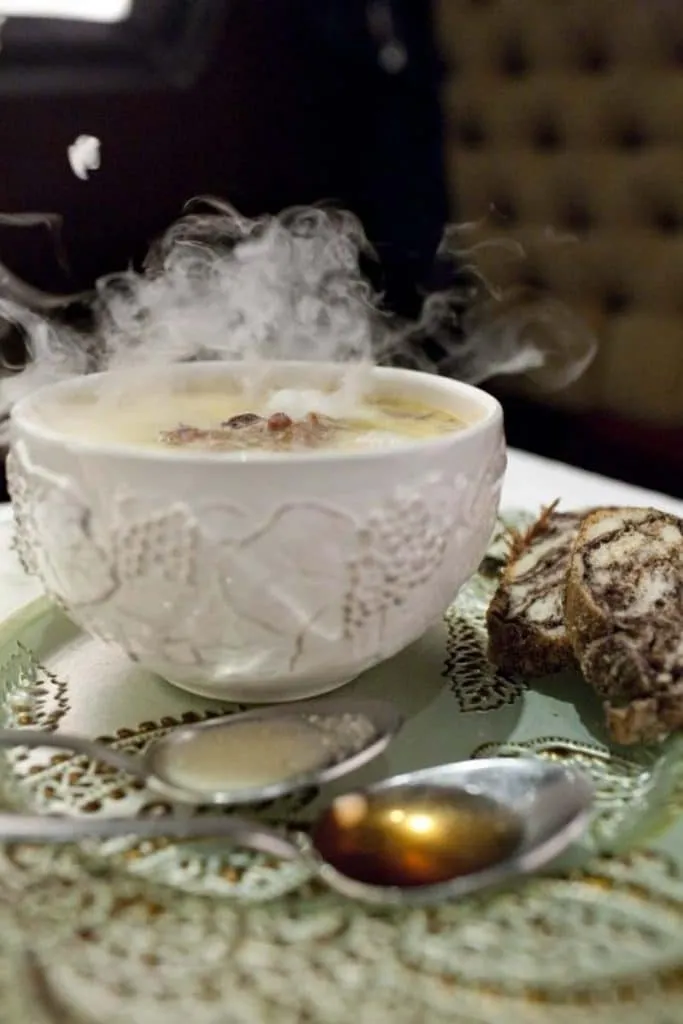 A steaming bowl of soup at Shorba, served with slices of dark bread on the side